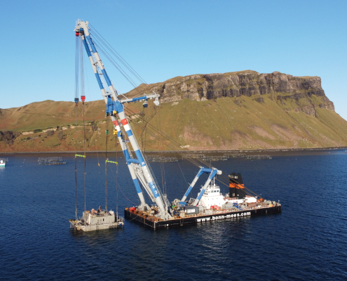 Sheerleg platform with support vessel along coast